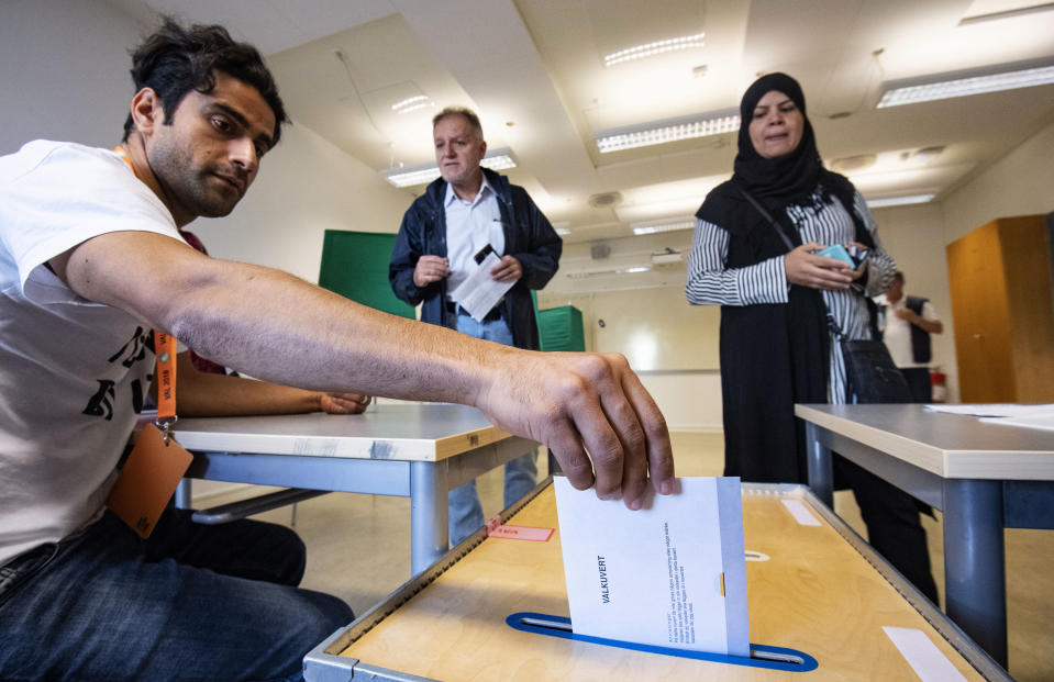 An Electoral counselor posts an election envelope in a polling station in Malmo, Sweden, Sunday Sept. 9, 2018. Polls have opened in Sweden's general election in what is expected to be one of the most unpredictable and thrilling political races in Scandinavian country for decades amid heated discussion around top issue immigration. (Johan Nilsson/TT via AP)