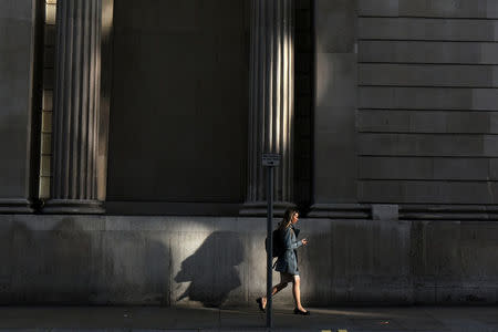 A pedestrian walks in the City of London, Britain October 18, 2017. Picture taken October 18, 2017. REUTERS/Mary Turner