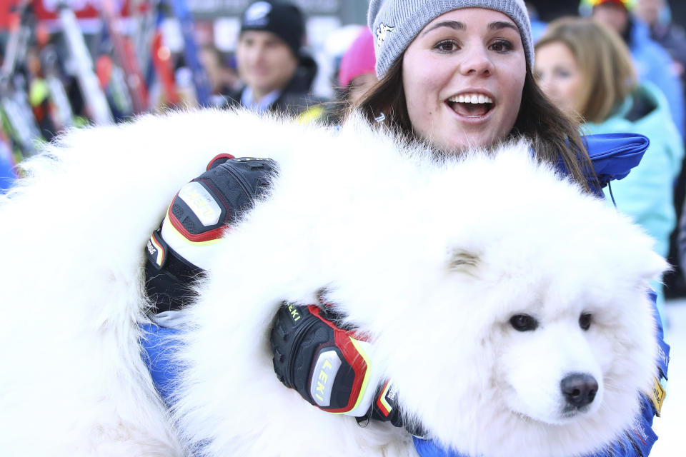Italy's Nicol Delago hugs her dog at the finish area during a ski World Cup Women's Downhill, in Val Gardena, Italy, Tuesday, Dec. 18, 2018. (AP Photo/Alessandro Trovati)