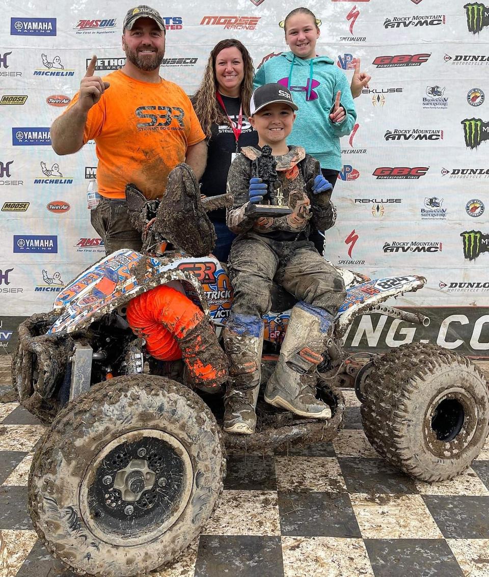 Dustin and Amy Dickerson with their children Raelynn and Bryson following an ATV race. Both the children have been riding since the time they can hold on. This past year they competed in 24 races.