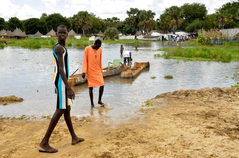 Children are seen near flood water from the broken dykes on Nile river, in Duk padiet county, Jonglei State