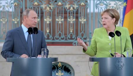 German Chancellor Angela Merkel speaks next to Russian President Vladimir Putin at the German government guest house Meseberg Palace in Gransee, Germany August 18, 2018. Sputnik/Alexei Druzhinin/Kremlin via REUTERS