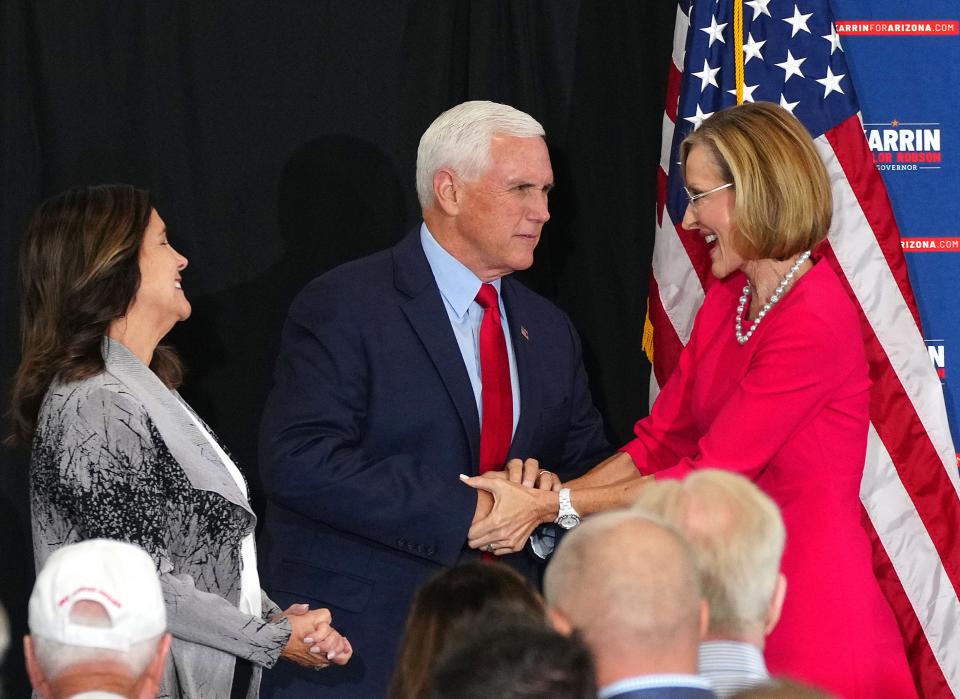 Former Vice President Mike Pence and his wife Karen Pence shake hands with gubernatorial candidate Karrin Taylor Robson during her campaign event at TYR Tactical on July 22, 2022, in Peoria.