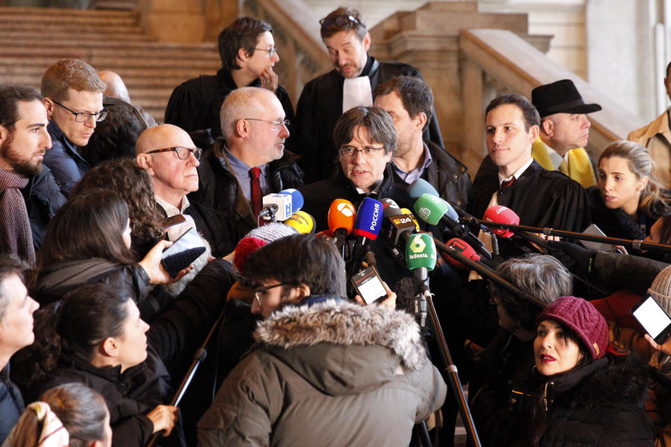 Catalonia's former regional president Carles Puigdemont speaks with journalists as he leaves the Justice Palace in Brussels, Monday, Dec.16, 2019. (AP Photo/Francois Walschaerts)