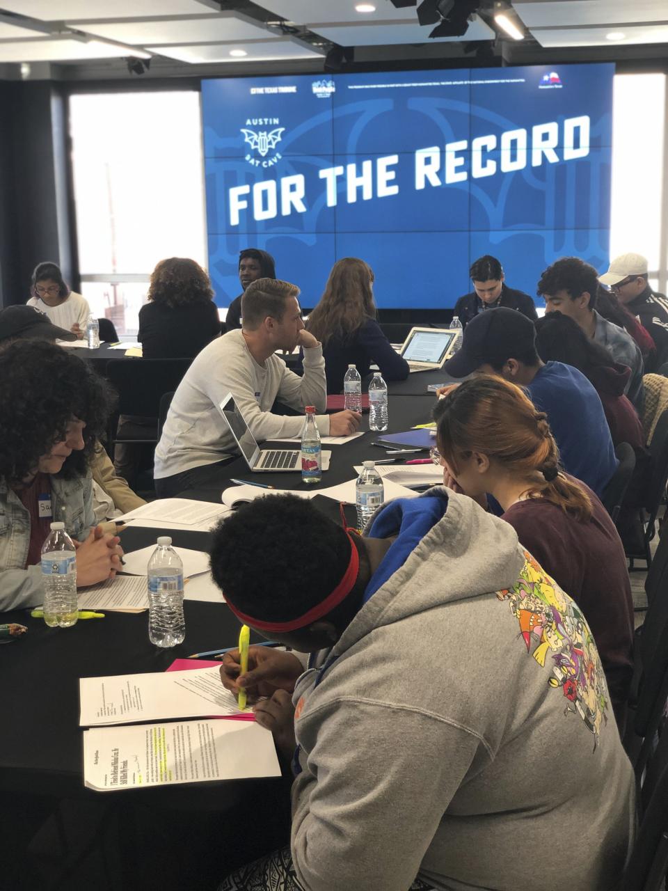 In this March 18th, 2018 photo provided by Syed Ali Haider, high school teens research and write op-eds on issues ranging from voting rights to gentrification during a three-day journalism workshop hosted by Austin Bat Cave at the Texas Tribune in Austin, Texas. Educators say teaching critical and creative writing is just as important as strong reading and is too often overlooked. "When students own their voices and tell their stories, they become not only stronger and more confident writers, but also stronger and more confident individuals," says Ali Haider, executive director of Bat Cave, the Austin-based creative writing center. (Syed Ali Haider via AP)