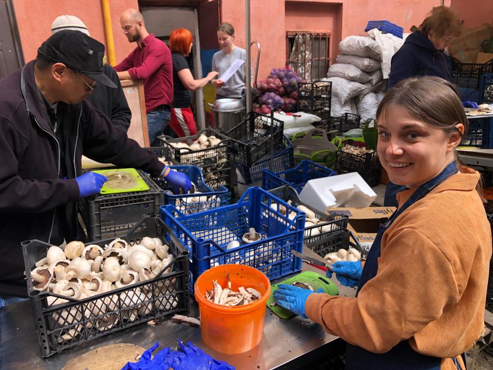 An unnamed volunteer works in May 2023 at FrontLine Kit, a volunteer agency, helping clean, cut, and prepare vacuum packed meals for soldiers in Lviv, Ukraine.