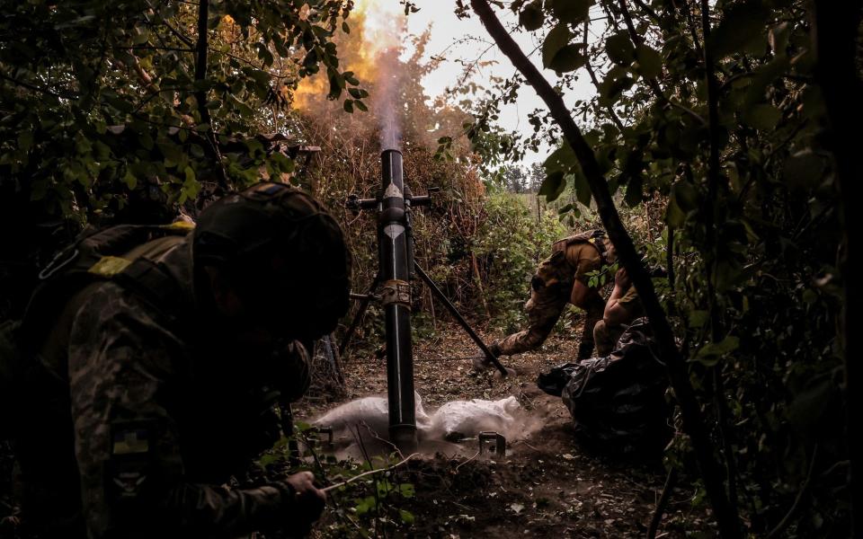 Servicemen of 24th Mechanized Brigade of the Ukrainian Armed Forces fire a 120-mm mortar towards Russian troops