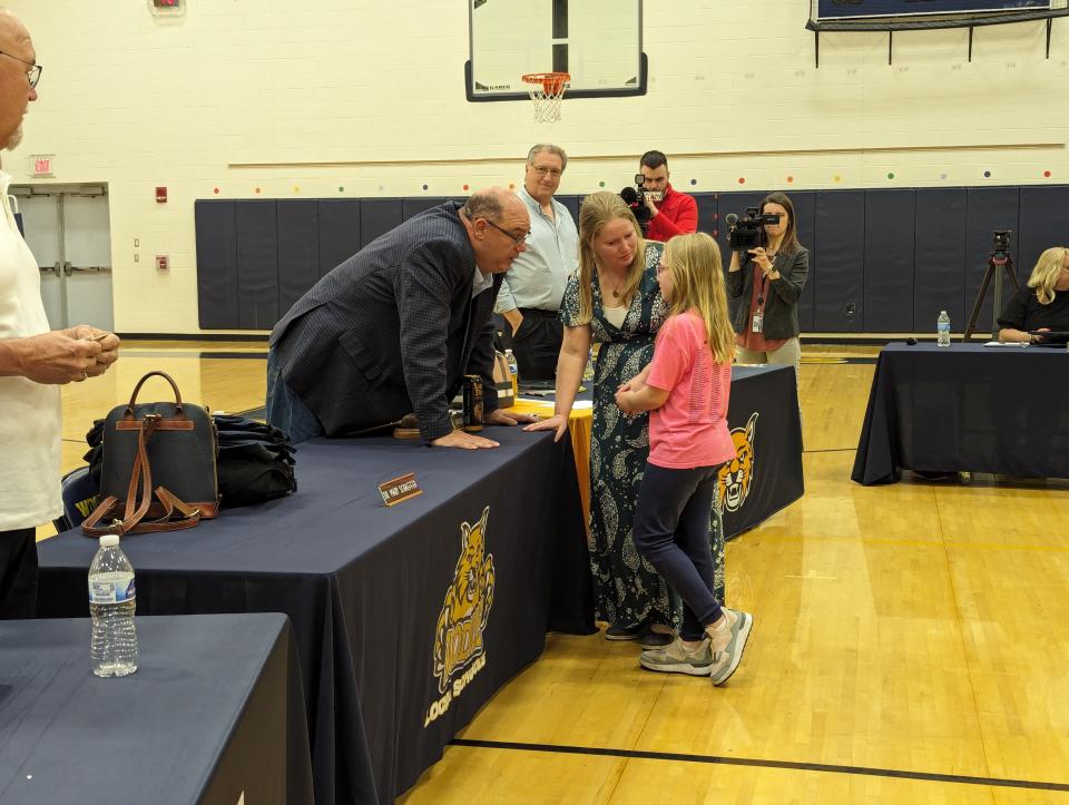 Sandy Widmer and her fifth-grade daughter, Abie, walked up at the end of the Woodmore School Board meeting. In tears, Abie spoke quietly with Board President Andy Miller.