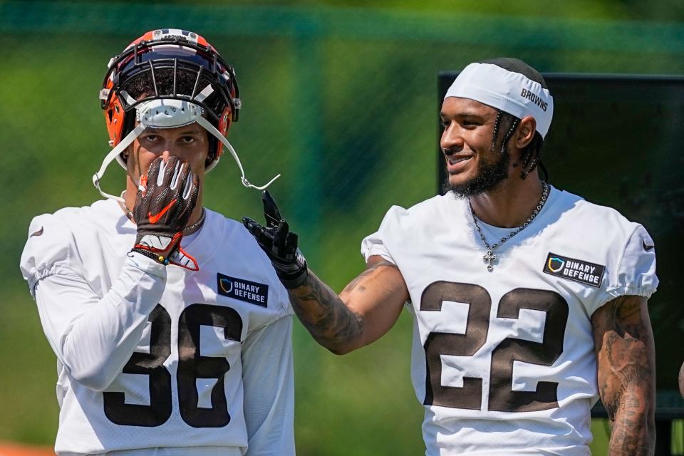Browns safety Grant Delpit, right, talks with Bubba Bolden during drills Monday.