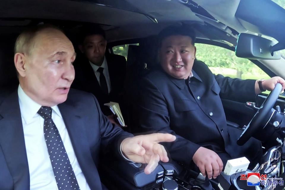 Kim Jong Un drives a car which was presented by Russia's President Vladimir Putin at a garden of the Kumsusan State Guest House in Pyongyang (AP)