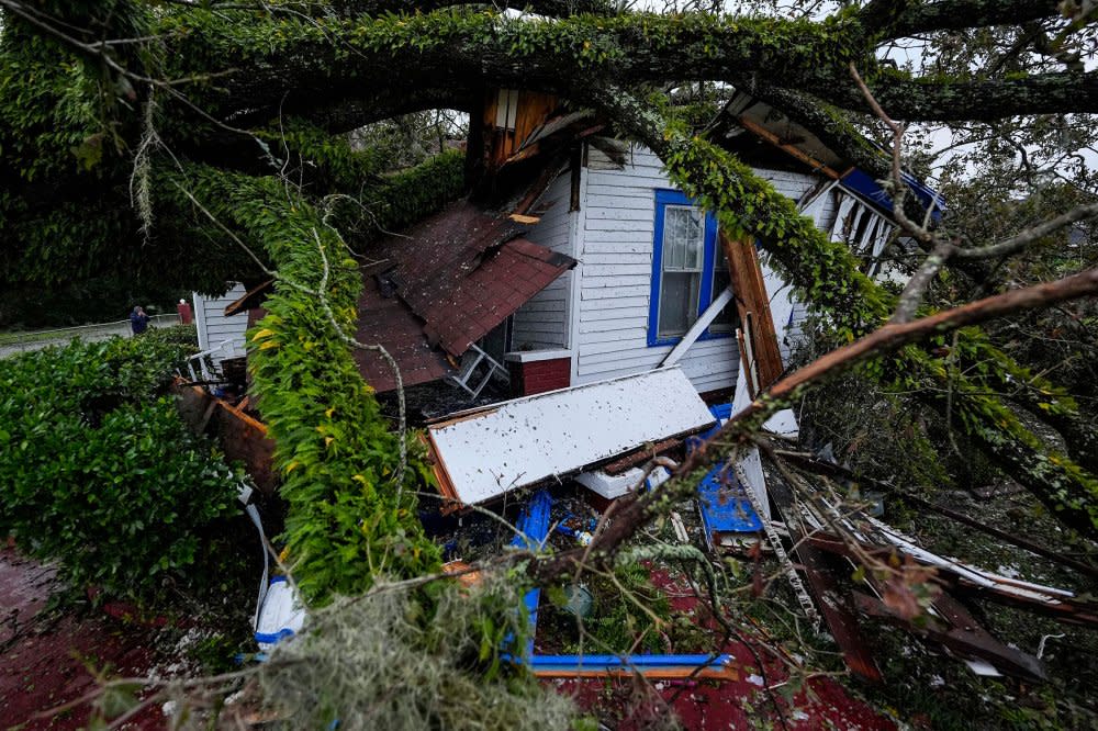 A damaged 100-year-old home is seen after an Oak tree landed on it after Hurricane Helene moved through Valdosta, Ga, on Sept. 27.<span class="copyright">Mike Stewart—AP</span>