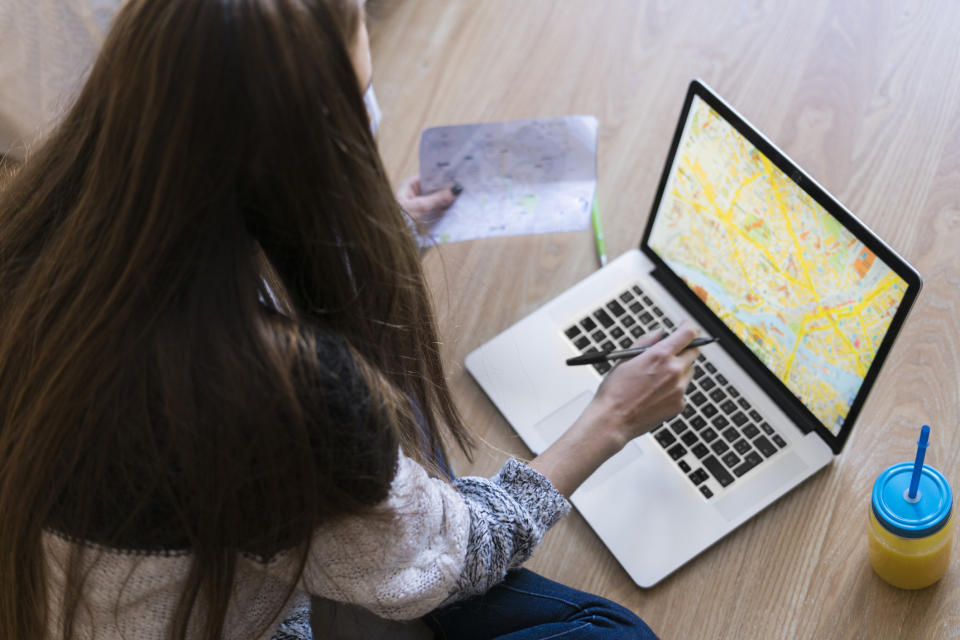 A woman planning a trip and looking at a map.