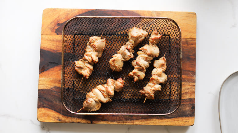 Chicken skewers in air fryer basket