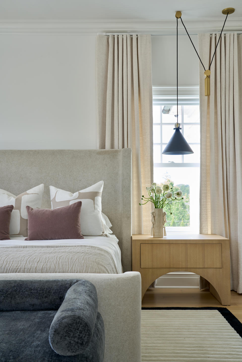 minimalist bedroom in light colors with  wood bedside table