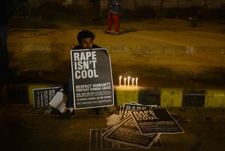 An Indian protester holds placards during a rally in New Delhi on December 31,2012. The family of an Indian gang-rape victim said Monday they would not rest until her killers are hanged as police finalised their investigation before charges are laid against suspects this week