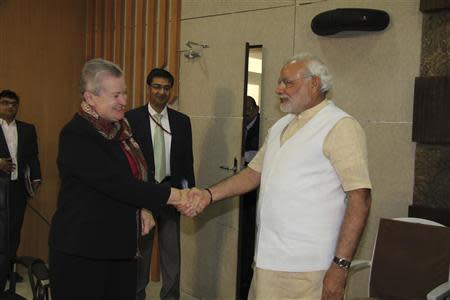 U.S. ambassador to India Nancy Powell (2nd L) shakes hands with Hindu nationalist Narendra Modi (R), prime ministerial candidate for India's main opposition Bharatiya Janata Party (BJP) and Gujarat's chief minister, during their meeting in Gandhinagar in the western Indian state of Gujarat February 13, 2014. REUTERS/Gujarat Information Department/Handout via Reuters