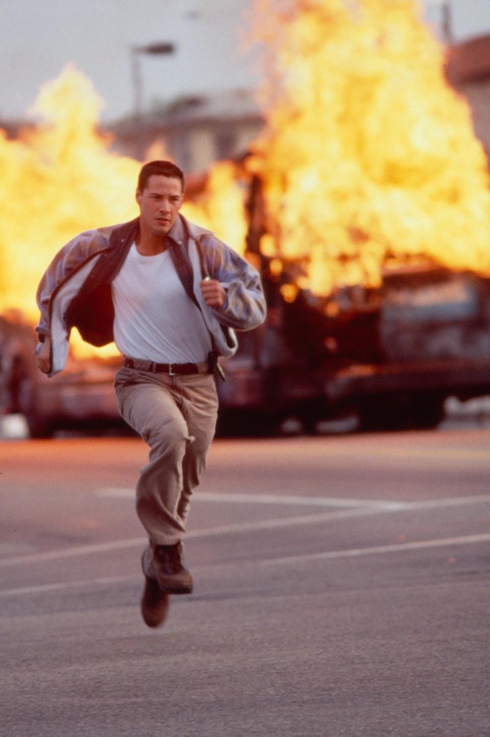 Keanu runs from an exploding car