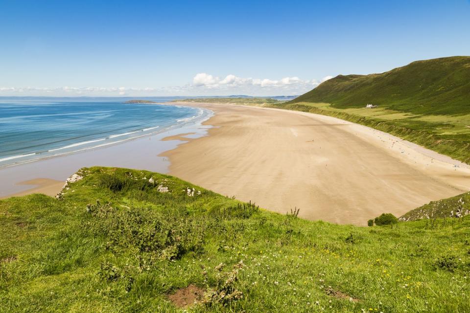 <p>No stranger to the best beaches in Wales lists, Rhossili Bay is three miles of dreamy sand and coastline on the Gower Peninsula that everyone, from walkers to watersports fans can appreciate. It's been voted the best beach in Britain and one of the 10 best in the world previously and never fails to impress, with its dramatic views and dog-friendliness. There's a steep walk down to it, which makes it unsuitable for pushchairs.</p><p><strong>Where to stay: </strong>Go for something unlike anywhere else and check into Bunkershill, an amazing property for a group of 12 people. It has glorious grounds with ponds, generous bedrooms and views over Mewslade Valley, the sea and Devon in the distance. It's also a 25-minute walk to Rhossili Bay.</p><p><a class="link " href="https://airbnb.pvxt.net/BXaKM0" rel="nofollow noopener" target="_blank" data-ylk="slk:SEE INSIDE;elm:context_link;itc:0;sec:content-canvas">SEE INSIDE</a> </p><p>Or experience the best of Gower from a cottage that sleeps six in Port Eynon, just 15 minutes away by car. </p><p><a class="link " href="https://www.holidaycottages.co.uk/cottage/72846-tiller-cottage" rel="nofollow noopener" target="_blank" data-ylk="slk:SEE INSIDE;elm:context_link;itc:0;sec:content-canvas">SEE INSIDE</a></p>