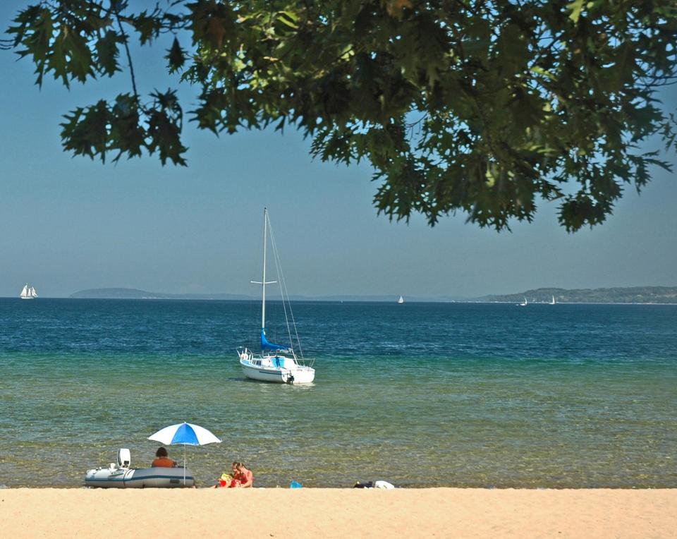 This undated photo released by the Traverse City Convention & Visitors Bureau shows West End Beach in Traverse City, one of many free-of-charge beaches on Lake Michigan’s Grand Traverse Bay. (AP Photo/Traverse City Convention & Visitors Bureau)