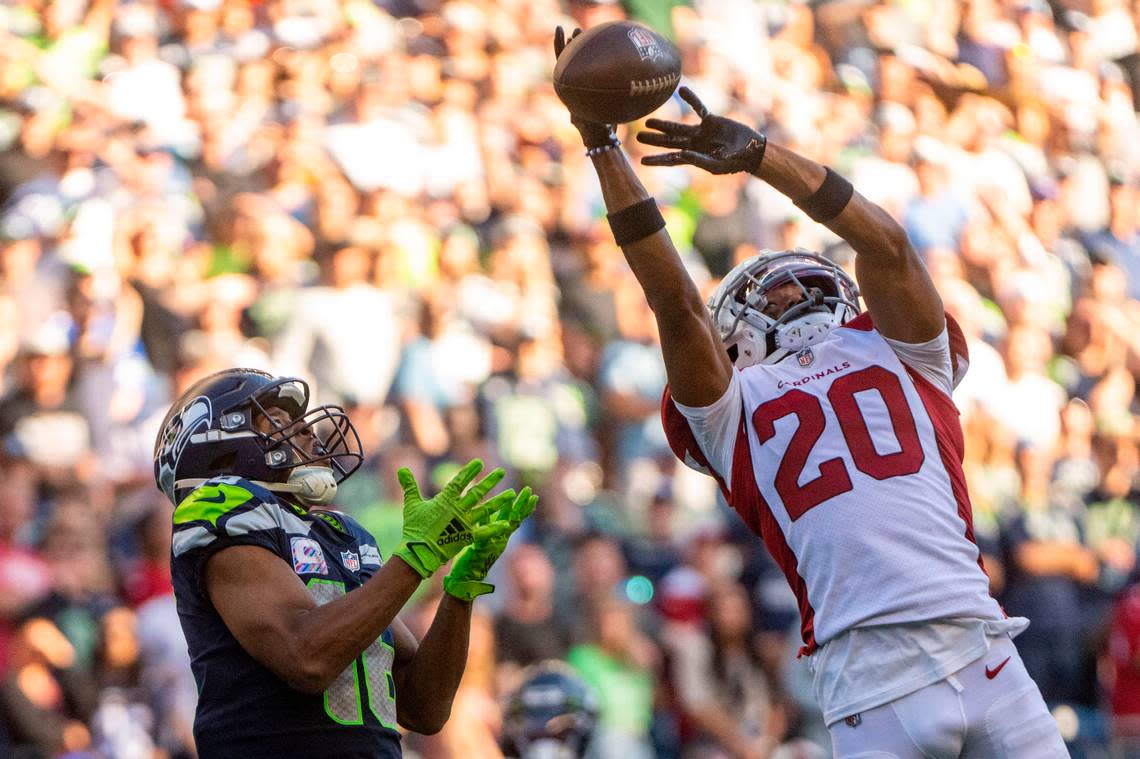 Arizona Cardinals cornerback Marco Wilson (20) breaks up a pass by Seattle Seahawks quarterback Geno Smith (7) that was intended for Seattle Seahawks wide receiver Tyler Lockett (16) during the fourth quarter of an NFL game on Sunday, Oct. 16, 2022, at Lumen Field in Seattle.