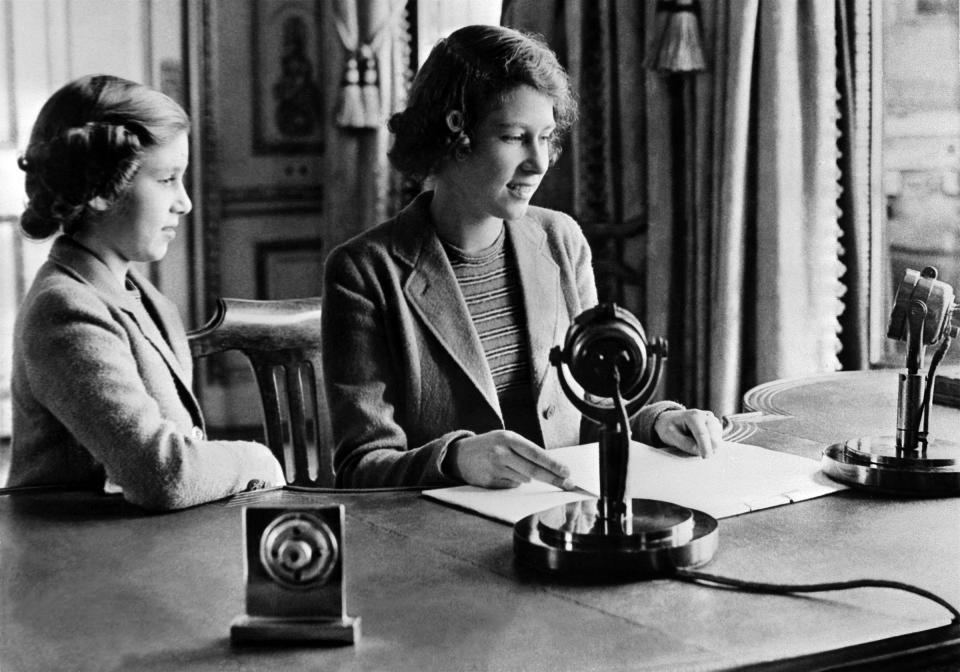 Princess Elizabeth, right, and her sister Princess Margaret send a message during the BBC's children programme, particularly to the children who were being evacuated because of the World War II, in Windsor in Oct. 1940.<span class="copyright">POOL/AFP/Getty Images</span>