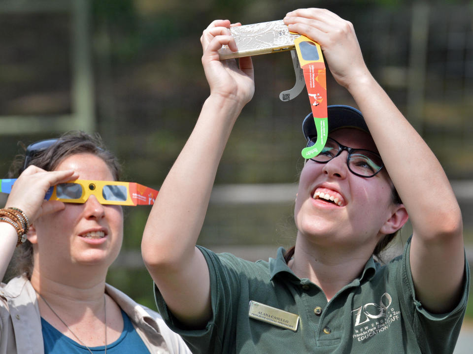 Spectators use viewing glasses to look at the eclipse on Aug. 21, 2017, in Boston, Massachusetts. / Credit: Chris Christo/MediaNews Group/Boston Herald via Getty Images