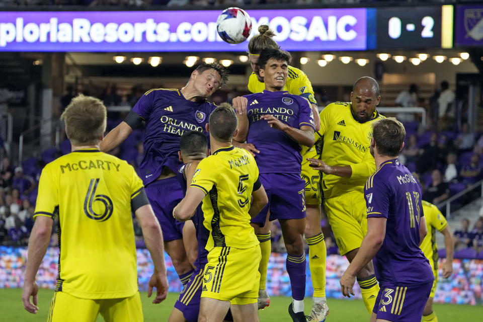 Orlando City's Rodrigo Schlegel, top left, and Ramiro Enrique (7) try to head the ball in the goal as Nashville SC's Brian Anunga, top right, tries to stop them during the second half of an MLS soccer match, Saturday, April 1, 2023, in Orlando, Fla. (AP Photo/John Raoux)