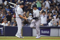 New York Yankees' Anthony Rizzo, right, is met by third base coach Phil Nevin after hitting a solo home run during the sixth inning of the team's baseball game against the Miami Marlins, Friday, July 30, 2021, in Miami. (AP Photo/Lynne Sladky)