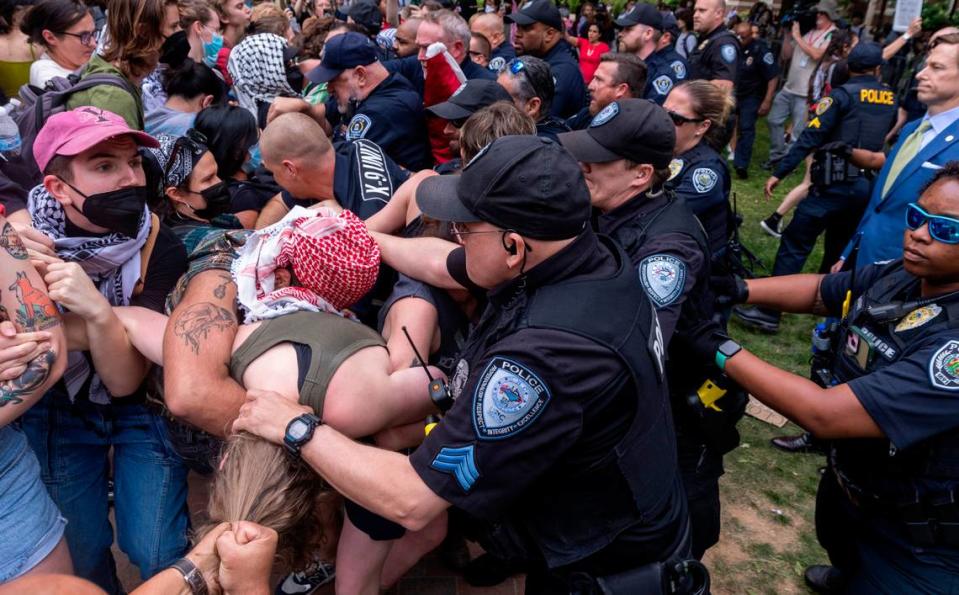 Pro-Palestinian demonstrators clash with police after replacing an American flag with a Palestinian flag Tuesday, April 30, 2024 at UNC-Chapel Hill. Police removed a “Gaza solidarity encampment” earlier Tuesday morning.