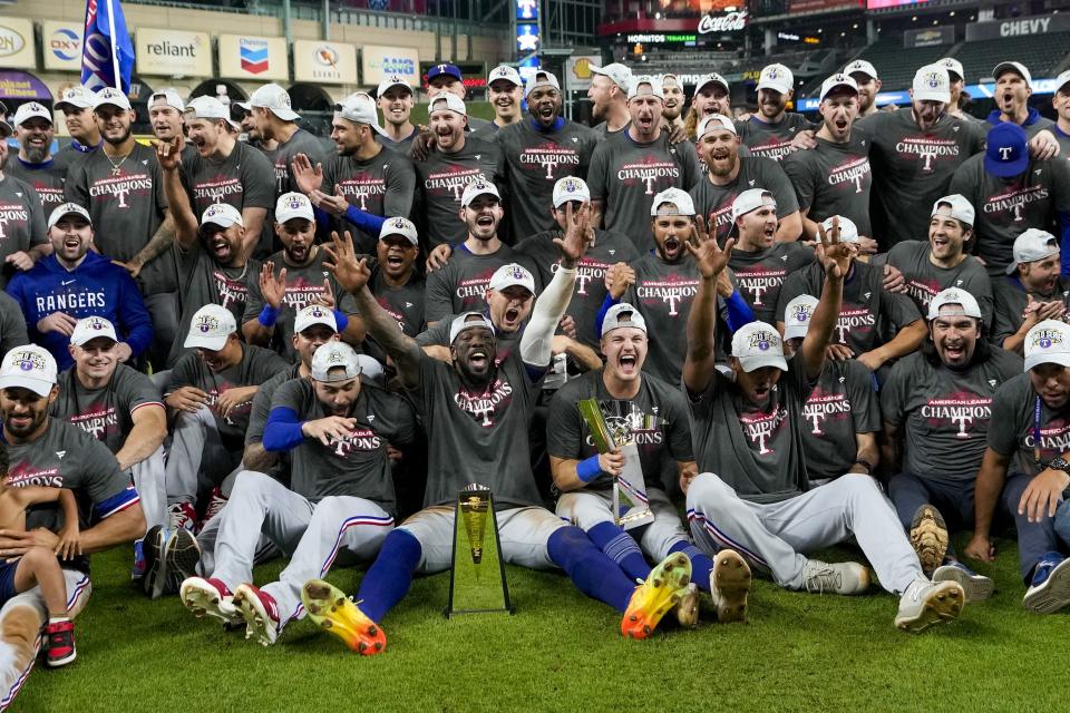 The Texas Rangers pose for a team picture after Game 7 of the baseball AL Championship Series against the Houston Astros Monday, Oct. 23, 2023, in Houston. The Rangers won 11-4 to win the series 4-3. (AP Photo/David J. Phillip)