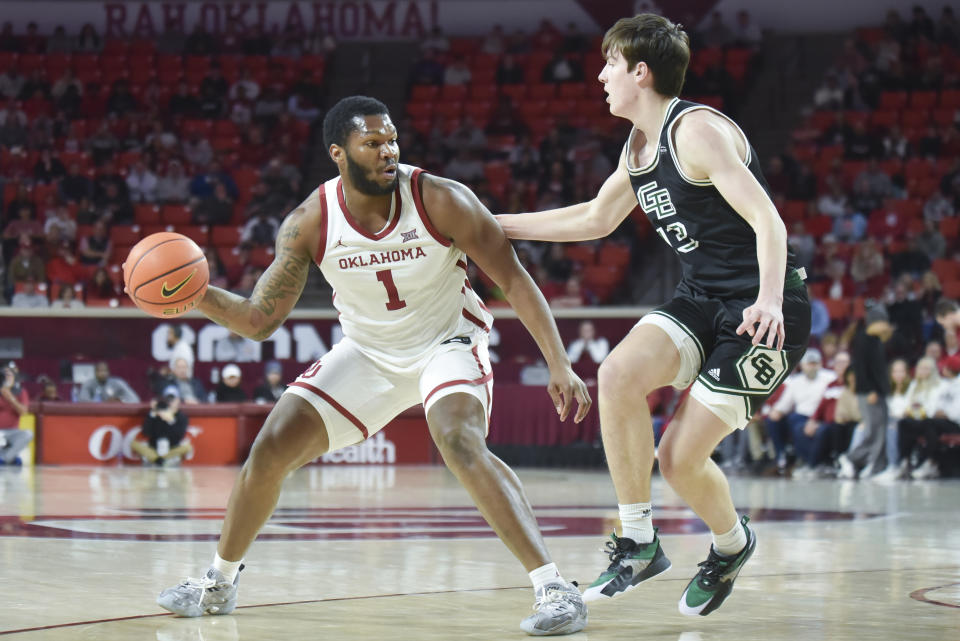 Oklahoma center John Hugley IV, left, tries to push past Green Bay forward Marcus Hall, right, during the first half of an NCAA college basketball game, Saturday, Dec. 16, 2023, in Norman, Okla. (AP Photo/Kyle Phillips)