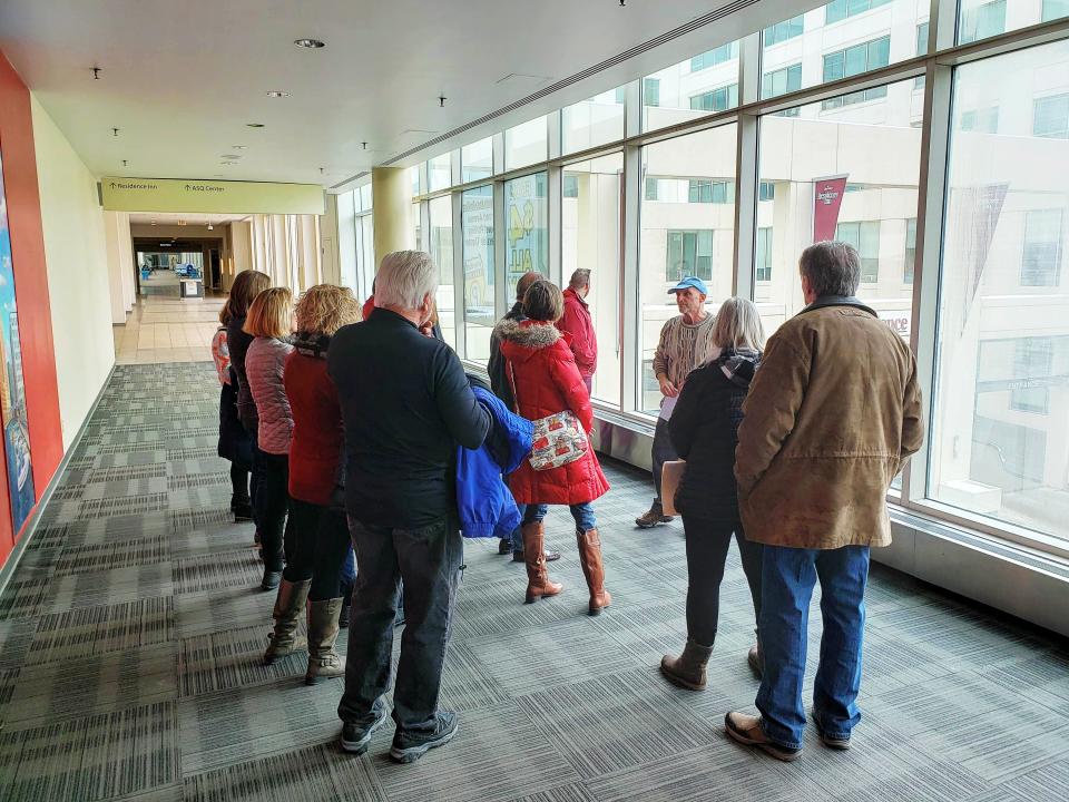 A tour group listens as Steve Kessel (center, in blue hat) talks about Milwaukee history on a Skywaukee tour with Historic Milwaukee on March 2, 2019. Historic Milwaukee also offers self-guided tour maps.