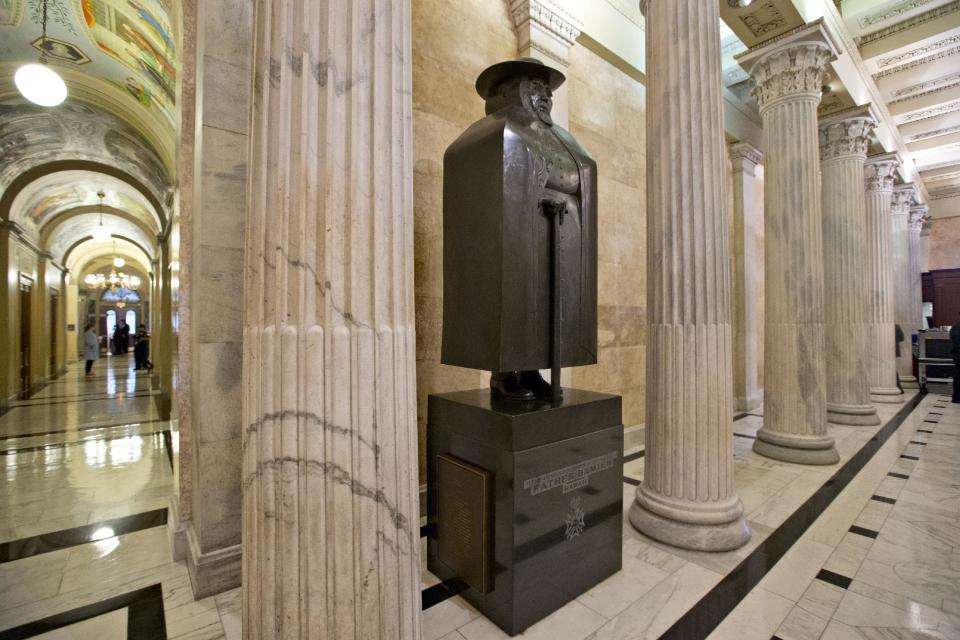 One of Hawaii's two scuplture in the state collection, the other being King Kamehameha, is Father Damien, the Belgian Catholic missionary who devoted his life to helping Hawaii's natives who suffered from diseases brought to the islands by foreign traders and sailors, at the Capitol in Washington, Tuesday, July 2, 2013. The bronze statue of Father Damien by Marisol Escobar is in a corridor in the House of Representatives, off the regular tourist path. (AP Photo/J. Scott Applewhite)