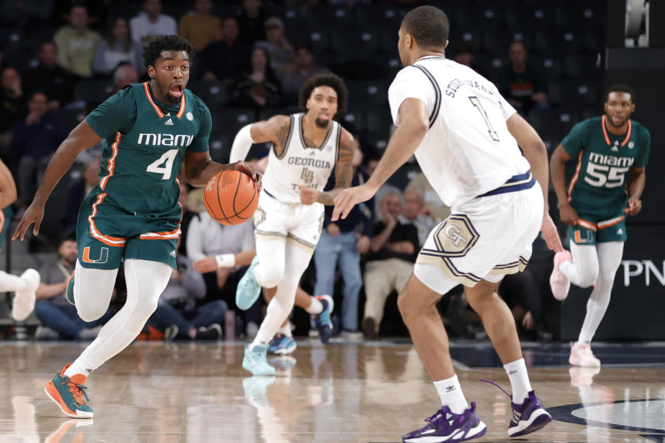 Miami guard Bensley Joseph, left, brings the ball up against Georgia Tech guard Kyle Sturdivant, right, during the second half of an NCAA college basketball game Wednesday, Jan. 4, 2023, in Atlanta. Georgia Tech won 76-70. (AP Photo/Alex Slitz)