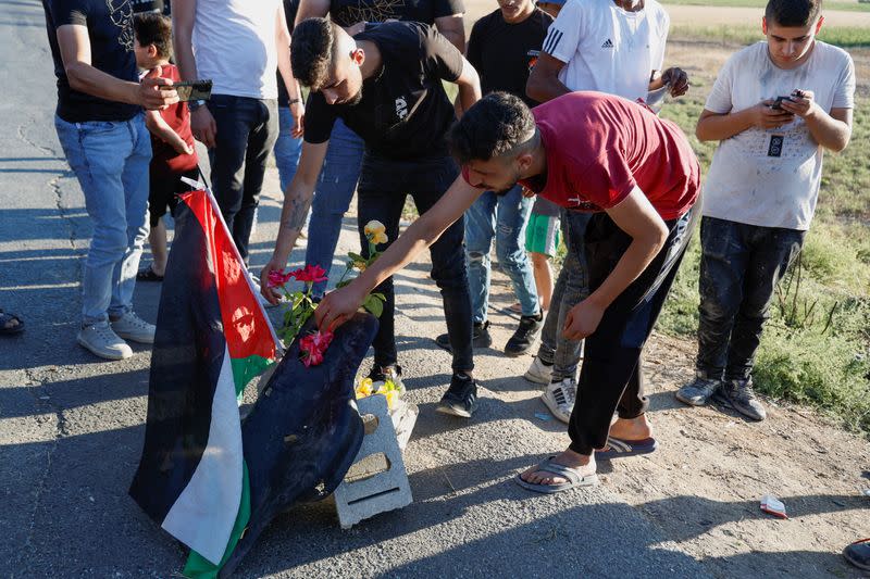 Palestinians gather at the scene where Israeli forces targeted a Palestinian car, near Jenin