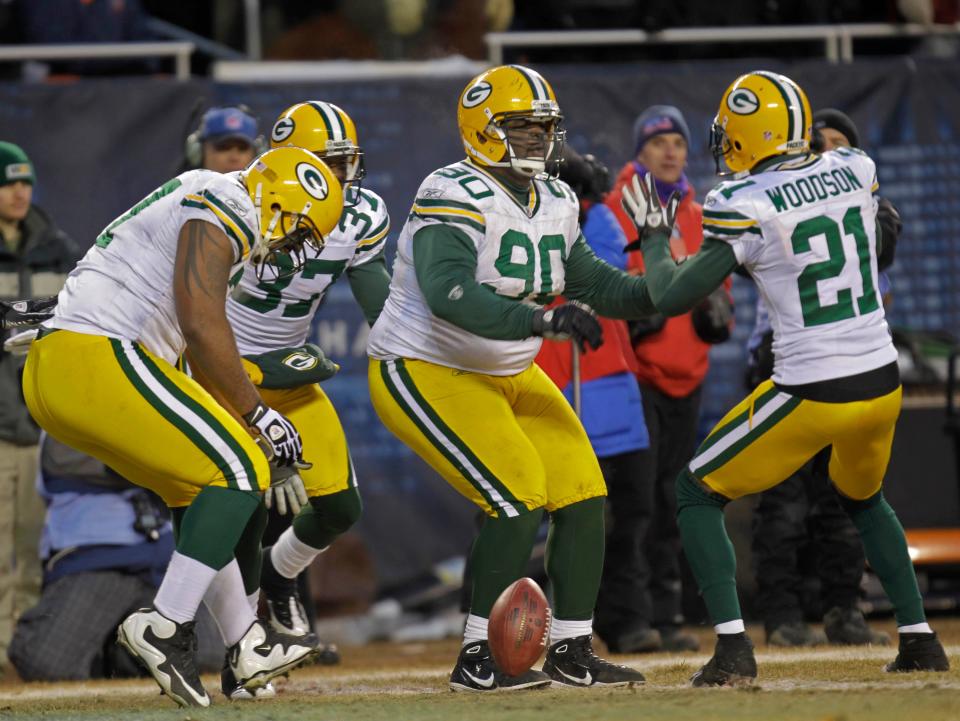 Green Bay Packers defensive tackle B.J. Raji (90) and Green Bay Packers cornerback Charles Woodson (21) celebrate B.J. Raji's touchdown during the NFC Championship game between the Green Bay Packers and the Chicago Bears, Sunday, January 23, 2011 at Soldier Field in Chicago.