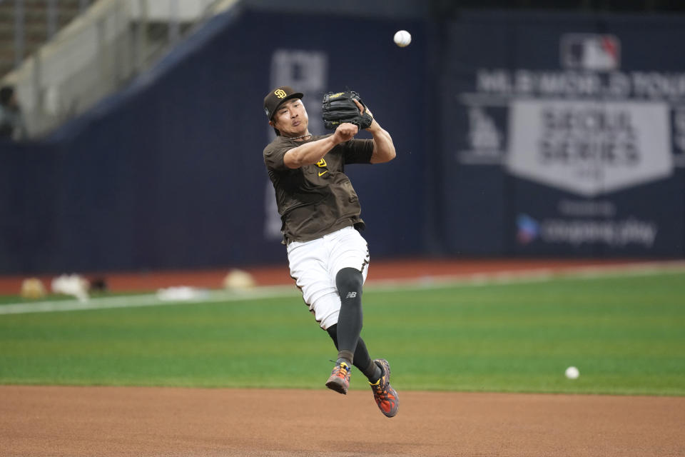 San Diego Padres Ha-Seong Kim fields a ground ball during a baseball workout at the Gocheok Sky Dome in Seoul, South Korea, Tuesday, March 19, 2024. Major League Baseball's season-opening games between the Los Angeles Dodgers and San Diego Padres in Seoul will be the first MLB games held in the baseball-loving nation.(AP Photo/Lee Jin-man)