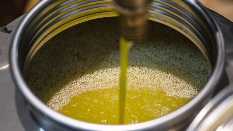 Pressing fresh olive oil