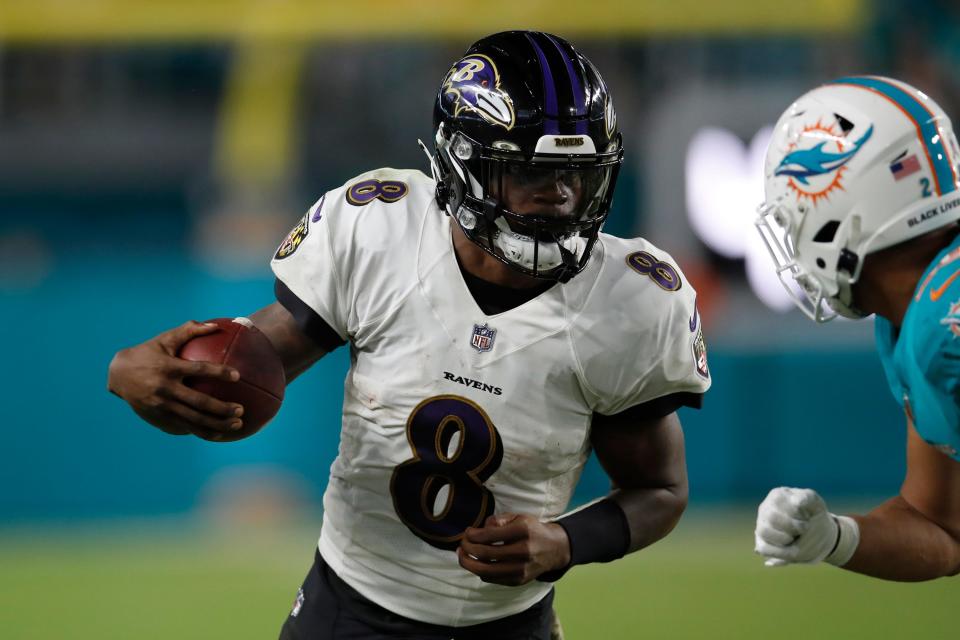 Baltimore Ravens quarterback Lamar Jackson (8) runs the ball against the Miami Dolphins during an NFL football game, Thursday, Nov. 11, 2021, in Miami Gardens, Fla.