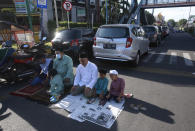 Muslim men pray on a street outside a crowded Al Mashun Great Mosque during an Eid al-Fitr prayer in Medan, North Sumatra, Indonesia, Thursday, May 13, 2021. Muslims celebrated Eid al-Fitr in a subdued mood for a second year Thursday as the COVID-19 pandemic again forced mosque closings and family separations on the holiday marking the end of Islam's holiest month of Ramadan. (AP Photo/Binsar Bakkara)