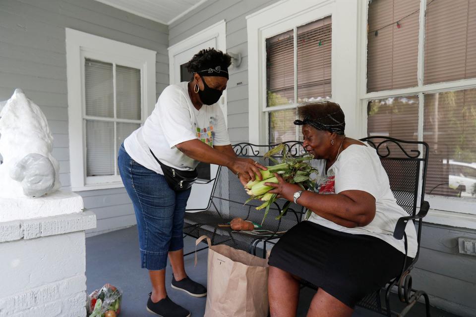 Ervenia Bowers delivers fresh vegetable from Farm Truck 912 to a West Savannah resident.