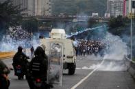 FILE PHOTO: Police fire tear gas toward opposition supporters during clashes while rallying against Venezuela's President Nicolas Maduro in Caracas, Venezuela, April 20, 2017. REUTERS/Carlos Garcia Rawlins