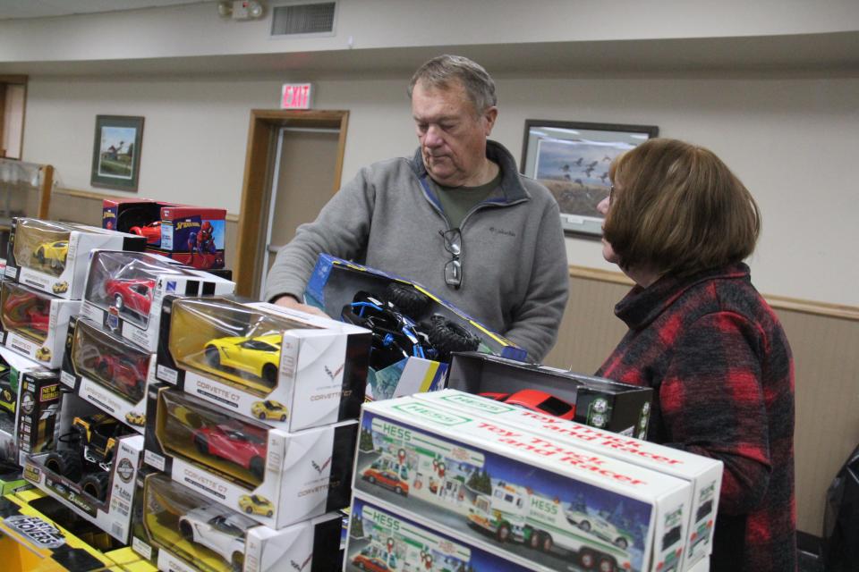 Dennis and Sharon Ulrich pick out toys on Monday, Dec. 4, 2023, for the annual toy drive.