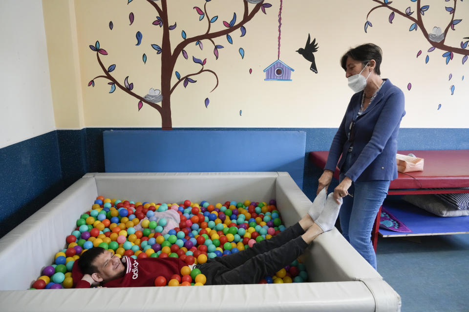 Doctor Loredana Moretti, right, jokes with Riccardo Mure' inside the Chicco community of L'Arche, an International charity that helps people with intellectual disabilities, in Ciampino, near Rome, Wednesday, March 22, 2023. The findings of expert reports commissioned by L’Arche itself reveal that their founder, Jean Vanier, perverted Catholic doctrine to justify his own sexual compulsions and abuse women and that the movement he created had at its core a secret, a mystical-sexual “sect” founded for the precise purpose of hiding the sect’s deviant activities from church authorities. (AP Photo/Gregorio Borgia)