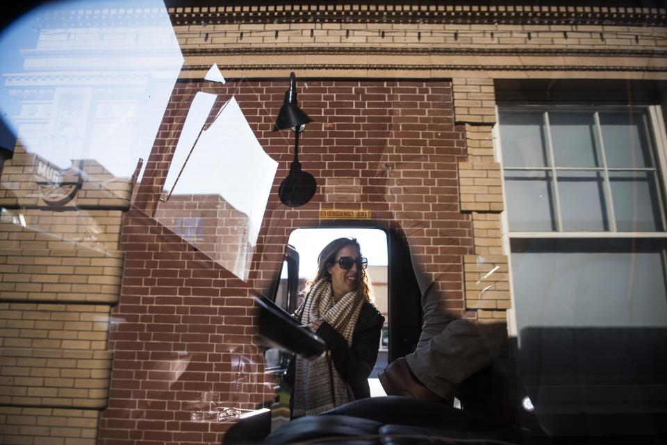 Rebecca Halperin&nbsp;steps into the bus, whose surface reflects&nbsp;the Livingston Depot Center.