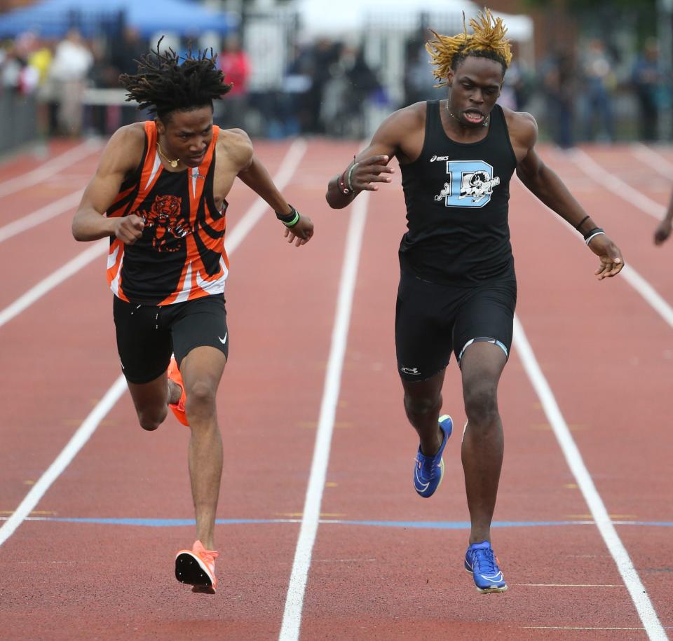 A.I. du Pont's Camerin Williams (left) and Dickinson's Jakai Robinson lean at the finish line as Williams wins the Division I 400 meter race by .01 seconds during the second day of the DIAA state high school track and field championships at Dover High School, Saturday, May 18, 2024.