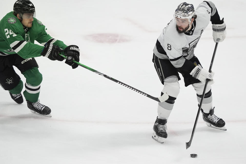 Los Angeles Kings defenseman Drew Doughty (8) tries to keep the puck from Dallas Stars center Roope Hintz during the second period an NHL hockey game in Dallas, Saturday, March 16, 2024. (AP Photo/LM Otero)