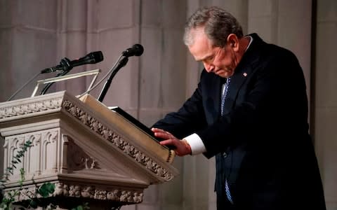 Former US President George W. Bush speaks at the State Funeral for his father, former US President George H W Bush - Credit: ALEX BRANDON/AFP