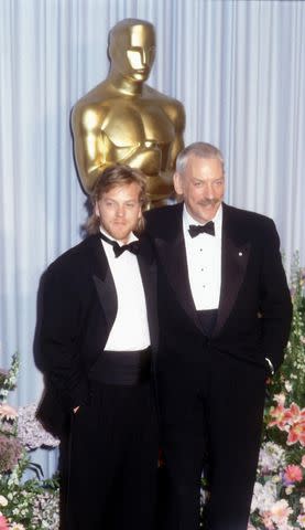 <p>Barry King/WireImage</p> Kiefer Sutherland and Donald Sutherland at the Academy Awards in 1989