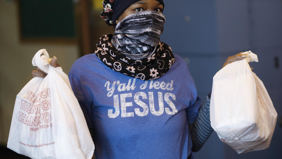 Volunteer Delores Wyatt prepares bags of food for distribution at the Brightmoor Connection Food Pantry in Detroit on Monday. (Photo: ASSOCIATED PRESS)